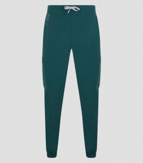 Pantalón sanitario tipo jogger unisex Avani color Verde jungla en tejido stretch con diez bolsillos y puño elástico